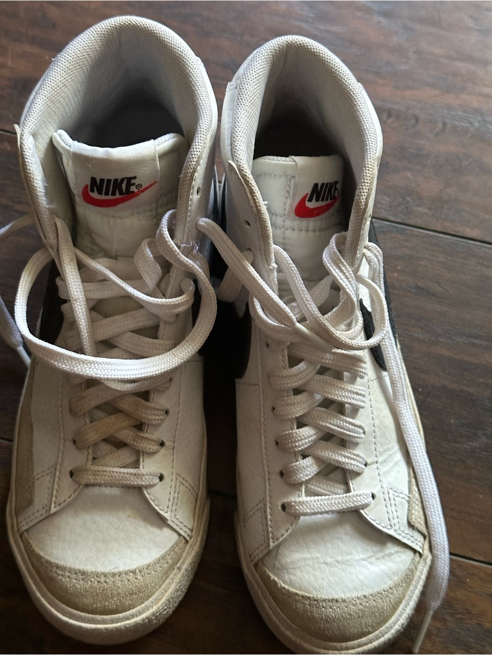 Nike White High-Top Sneakers with Black Swoosh and Red Logo
